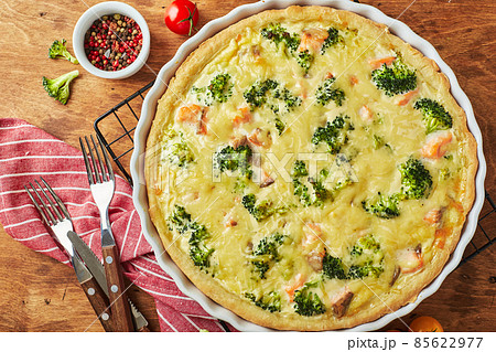 Homemade quiche with red fish, salmon, broccoli and cheese on wooden background Homemade quiche with red fish, salmon, broccoli and cheese on wooden background 85622977