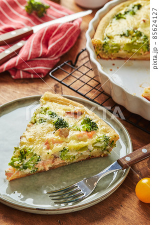 Homemade quiche with red fish, salmon, broccoli and cheese on wooden background Homemade quiche with red fish, salmon, broccoli and cheese on wooden background 85624127