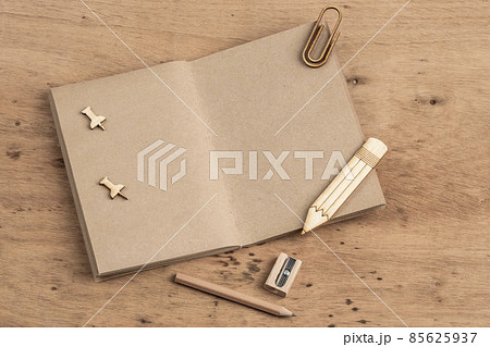 Blank notebook opened on a wooden table with copy space 85625937