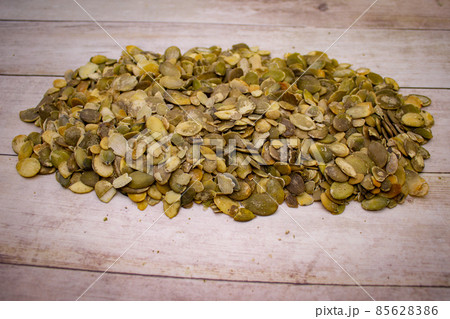 Pumpkin seeds on wooden background Pumpkin seeds on wooden background 85628386