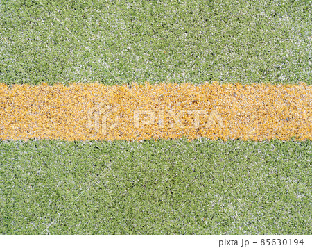 Yellow marks and lines on outdoor football or hanball playfield. 85630194