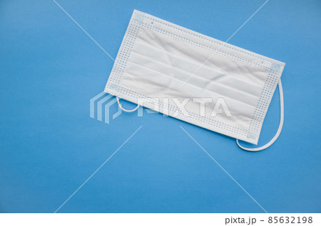 Medical mask isolated on background. Close-up of Coronavirus or COVID-19 protective face mask. Workwear prevents entry of Alpha, Beta, Gamma, Delta, Omicron into a body. Travel rules tightened over  85632198