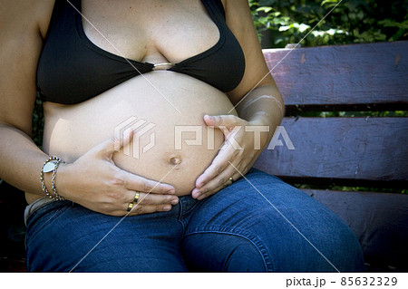 Seven month pregnant woman in a park Seven month pregnant woman in a park 85632329
