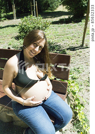 Seven month pregnant woman in a park Seven month pregnant woman in a park 85632333