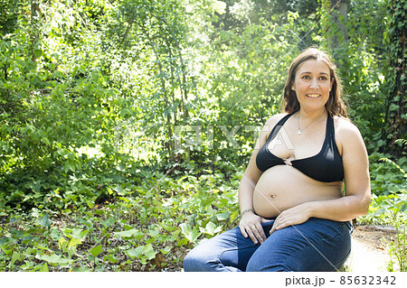 Seven month pregnant woman in a park Seven month pregnant woman in a park 85632342