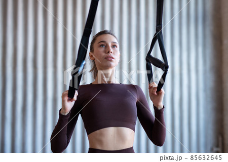 Fit woman training with fitness trx straps Fit woman training with fitness trx straps 85632645