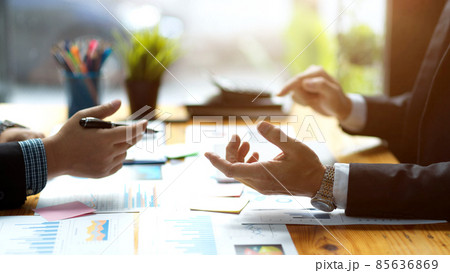 a businessmen discussing and analysing financial data works. a businessmen discussing and analysing financial data works. 85636869