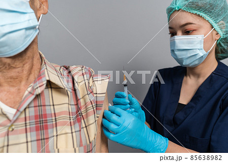 doctor make injection Covid-19 or coronavirus vaccine to senior patient in mask doctor make injection Covid-19 or coronavirus vaccine to senior patient in mask 85638982