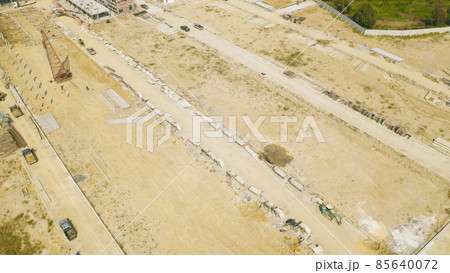 Aerial top view of dry ground rough cracks in the land with sand in factory industry for construction site. Arid pattern texture background. Aerial top view of dry ground rough cracks in the land with sand in factory industry for construction site. Arid pattern texture background. 85640072