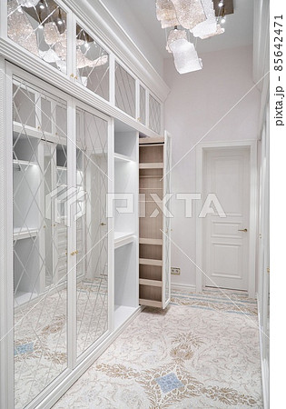 White walk-in closet with vertical slide out wooden cabinet 85642471