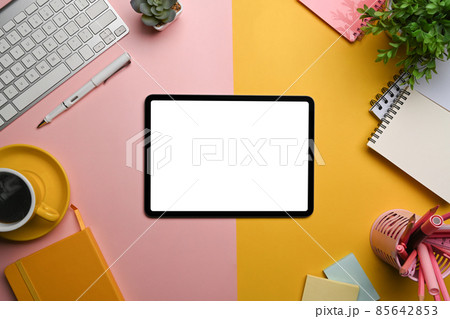 Top view digital tablet, coffee cup and supplies on colorful background. Top view digital tablet, coffee cup and supplies on colorful background. 85642853