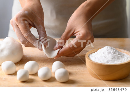Hand making Tangyuan, Chinese dessert made of ball glutinous rice flour 85643479