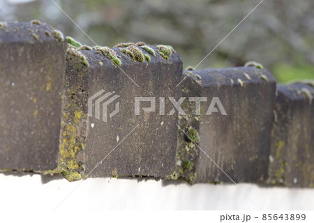 Grey rooftiles on a 20 year old building 85643899