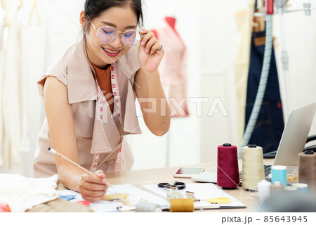 Asian young women fashion designer  working on her designer in the showroom 85643945