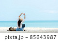 Lifestyle freelance woman raise arms relax after using laptop working on the beach.  85643987