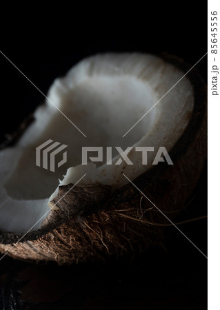 Chopped coconut on a wooden board close up 85645556