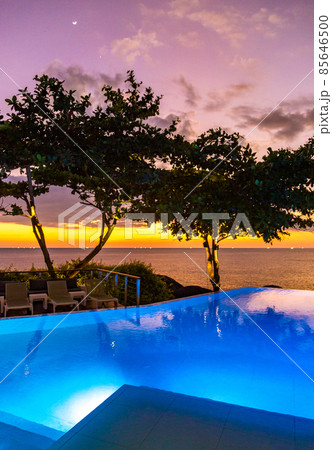 Sunset at the edge of a swimming pool at Kata beach in Phuket province, in Thailand 85646500