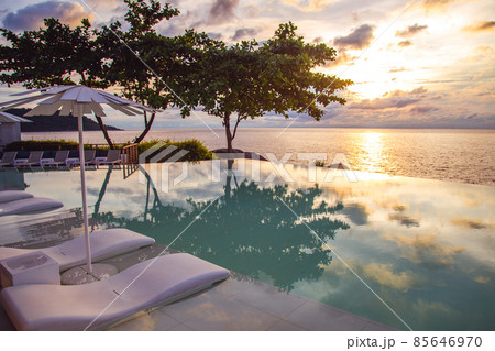 Sunset at the edge of a swimming pool at Kata beach in Phuket province, in Thailand 85646970