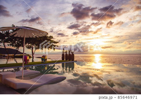 Sunset at the edge of a swimming pool at Kata beach in Phuket province, in Thailand Sunset at the edge of a swimming pool at Kata beach in Phuket province, in Thailand 85646971