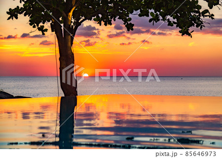 Sunset at the edge of a swimming pool at Kata beach in Phuket province, in Thailand 85646973