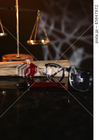 Document with wax seal, scales and antique stamp on a desk. Last will and legacy concept 85647672