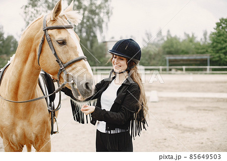 Portrait of riding horse with woman in black helmet 85649503