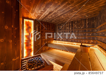 Empty wooden steam room with stone heater Empty wooden steam room with stone heater 85649737
