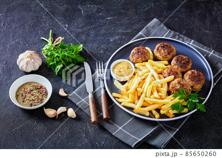 Vitoulet, hot Belgian meatballs with french fries Vitoulet, hot Belgian meatballs with french fries 85650260