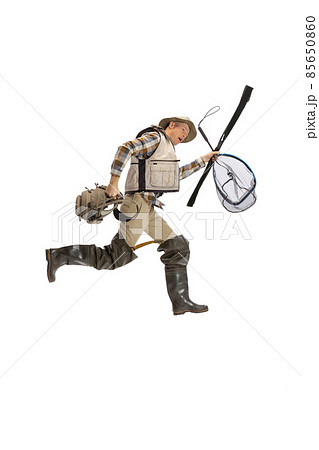 Portrait of young man, professional fisherman with fishing rod, spinning and equipment going to river isolated over white studio background Portrait of young man, professional fisherman with fishing rod, spinning and equipment going to river isolated over white studio background 85650860