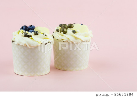 Two cupcakes on a pink background. Pair of cupcakes for lovers on a pink background 85651394