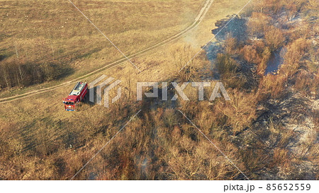 Aerial View. Spring Dry Grass Burns During Drought Hot Weather. Bush Fire And Smoke. Fire Engine, Fire Truck On Firefighting Operation. Wild Open Fire Destroys Grass. Ecological Problem Air Pollution Aerial View. Spring Dry Grass Burns During Drought Hot Weather. Bush Fire And Smoke. Fire Engine, Fire Truck On Firefighting Operation. Wild Open Fire Destroys Grass. Ecological Problem Air Pollution 85652559