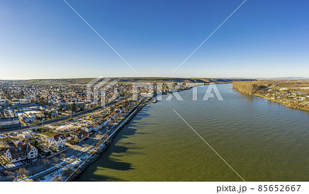 Drone image of wine village Nierstein on the Rhine in blue sky and sunshine with snow covered slopes Drone image of wine village Nierstein on the Rhine in blue sky and sunshine with snow covered slopes 85652667