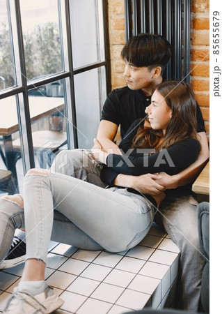 Asian young man hugging his caucasian girlfriend when they are s 85655679