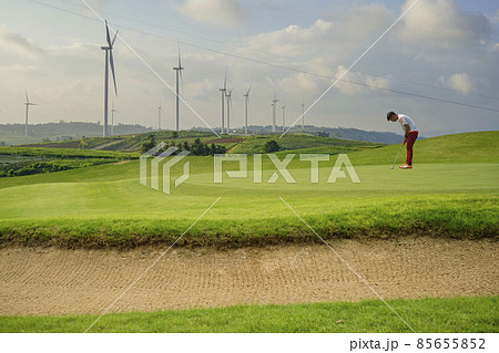 Golfers putting golf balls on the golf course in the morning. Golf man putting on green for birdie on the green golf.  85655852
