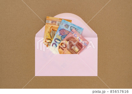 A pink envelope full of money A pink envelope full of money 85657616