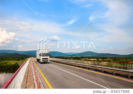 White Volvo truck on a bridge White Volvo truck on a bridge 85657986