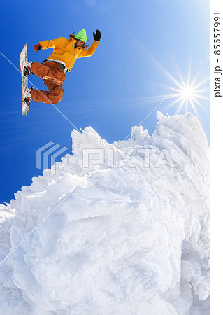 Snowboarder jumping against blue sky in high mountains 85657991