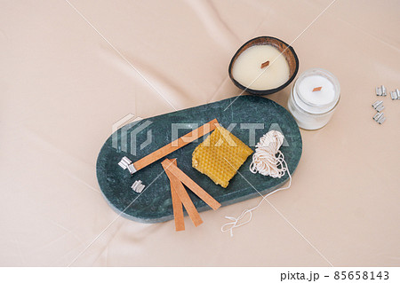 Close-up high-angle view of components for production of aromatic spa soy handmade candles on light background. 85658143
