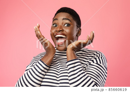 Joyful Black Female Shouting Holding Hands Near Face, Pink Background 85660619