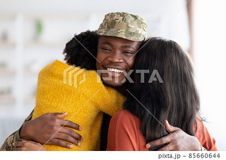 Wife And Daughter Embracing Happy Black Soldier Man After Returning Home 85660644