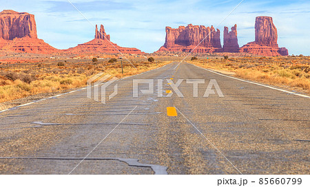 View to rocks of the Monument Valley alomg a road in the desert 85660799