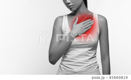 Cropped of female suffering from heartburn or breast pain Cropped of female suffering from heartburn or breast pain 85660819