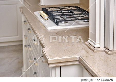 Gas stove cooktop on acrylic solid surface countertop in kitchen Gas stove cooktop on acrylic solid surface countertop in kitchen 85660820