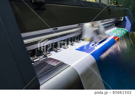 Large format inkjet printer working on vinyl paper in workplace Large format inkjet printer working on vinyl paper in workplace 85661502