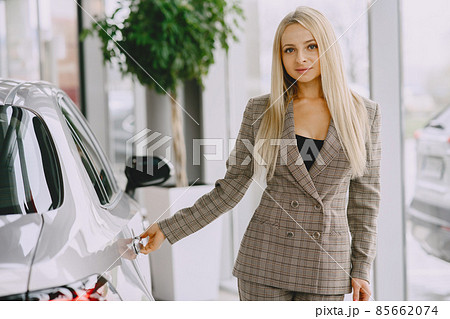 Stylish and elegant woman in a car salon Stylish and elegant woman in a car salon 85662074