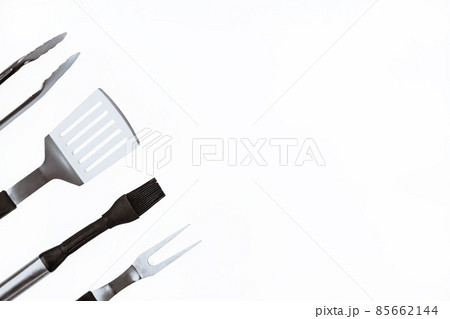 Set with barbecue utensils on white background. Stainless steel spatula, oil brush, tongs, fork for bbq. Copy space Set with barbecue utensils on white background. Stainless steel spatula, oil brush, tongs, fork for bbq. Copy space 85662144