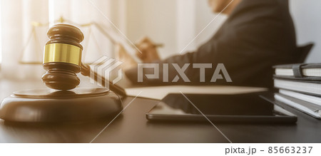 Professional lawyer considering with contract papers in courtroom. Justice, Law, Attorney and Court judge concept. Professional lawyer considering with contract papers in courtroom. Justice, Law, Attorney and Court judge concept. 85663237