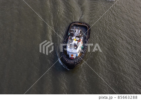 Aerial View of Tugboat in Fraser River and Mountain Landscape in background Aerial View of Tugboat in Fraser River and Mountain Landscape in background 85663288