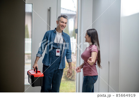 Woman inviting man to the house with tools Woman inviting man to the house with tools 85664919
