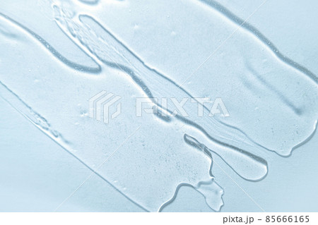 Liquid blue gel cosmetic smudge background. Water texture banner. Wallpaper for Korean cosmetics. Cream gel blue transparent cosmetic serum sample texture with bubbles on white background. Sanitizer  85666165